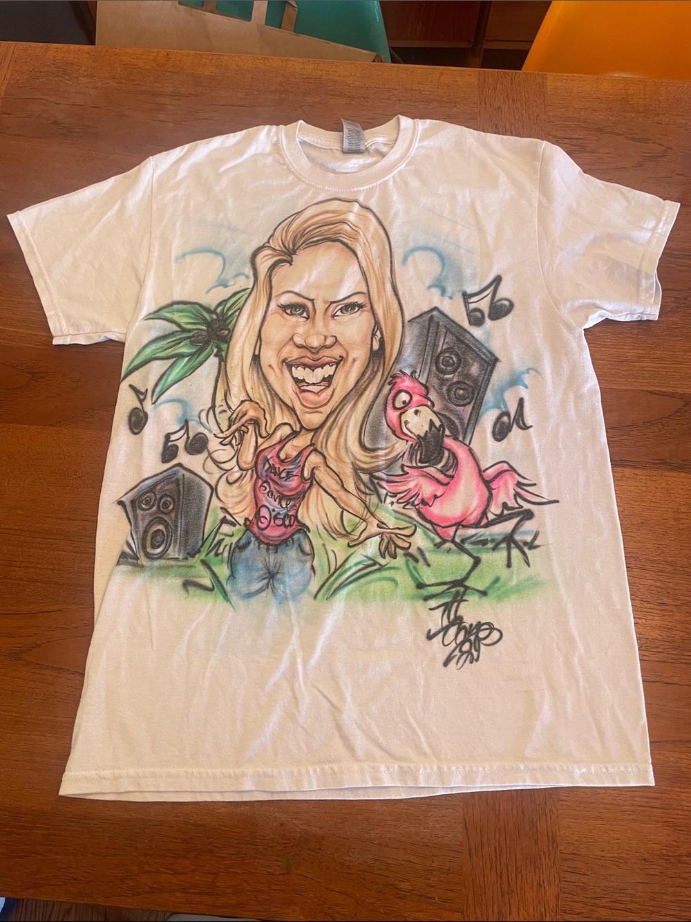 So M T-shirt airbrushed caricature of a blonde woman next to a pink flamingo